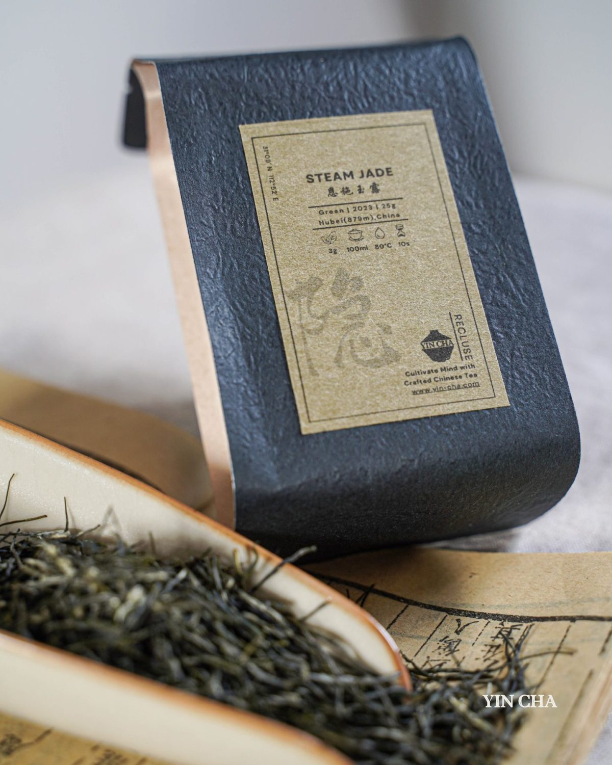 Steam Jade green tea bag with textured label and brewing instructions visible.