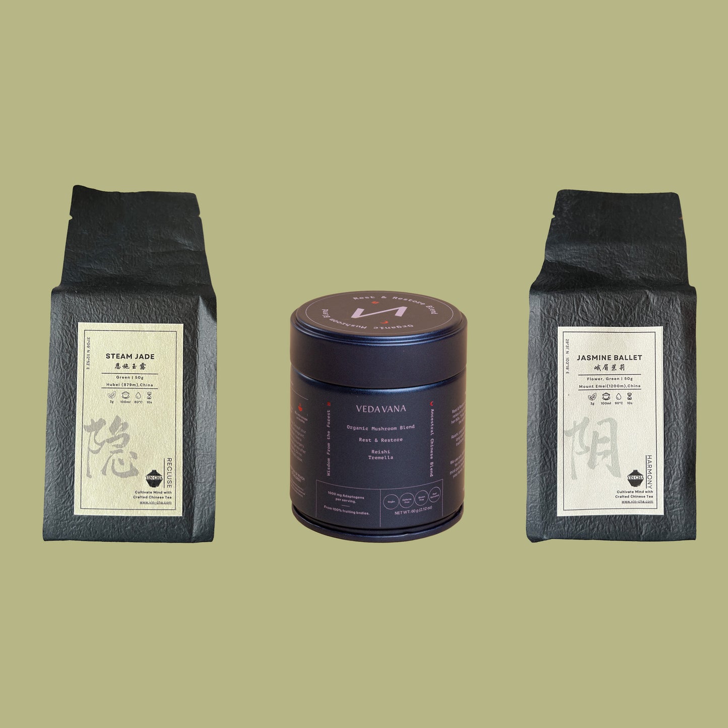 The green polyphenol kit with steam jade tea, jasmine ballet tea, and the veda vana dark blend container arranged on a green background.