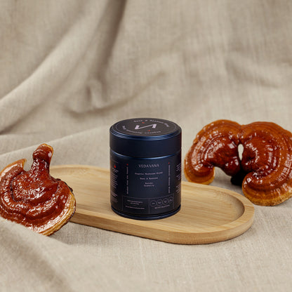 Vedavana Rest & Restore reishi organic mushroom extract powder with glossy reishi mushrooms on wooden tray
