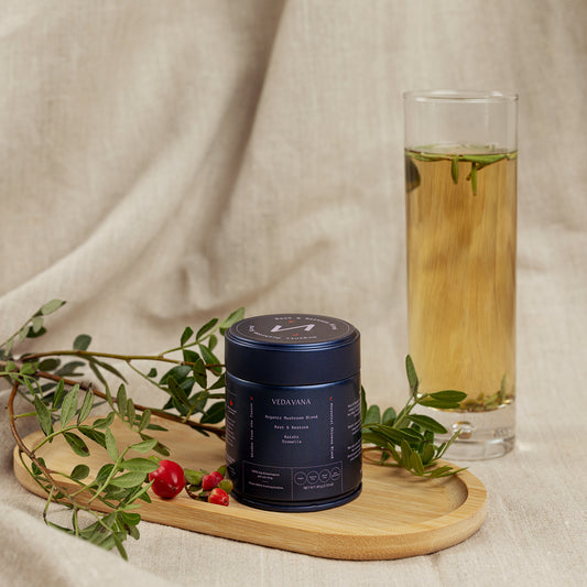 Rest & Restore organic mushroom blend by Vedavana with herbs and tea on wooden tray