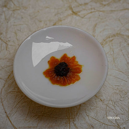Steeped Snow Chrysanthemum flower in a white ceramic bowl with petal details visible