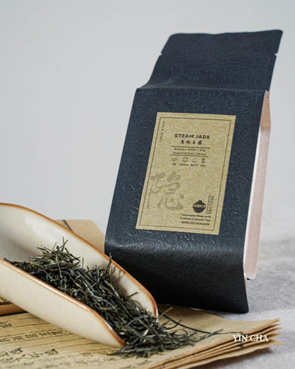 Steam Jade green tea packaging with loose leaves on traditional Chinese paper